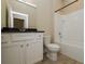 Well-lit bathroom with white cabinets, black granite countertops, and a shower-tub combo at 5909 Bibb Ct, North Port, FL 34288