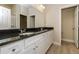 Bathroom featuring a double vanity with granite countertop, white cabinets, and neutral wall colors at 5909 Bibb Ct, North Port, FL 34288