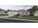 Charming one-story home with a gray roof, a two-car garage and a beautifully landscaped front yard at 5909 Bibb Ct, North Port, FL 34288