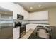 Modern kitchen with stainless steel appliances, granite counters, white cabinets, and subway tile backsplash at 5909 Bibb Ct, North Port, FL 34288