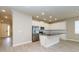 Modern kitchen with stainless steel appliances, granite countertops, white cabinets, and hardwood floors at 5909 Bibb Ct, North Port, FL 34288