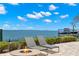Backyard patio area with fire pit, lounge chairs, and a view of the bay at 611 1St S Ave, Tierra Verde, FL 33715