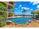 Backyard features a custom pool with a rock waterfall, tiki bar and private waterfront access at 611 1St S Ave, Tierra Verde, FL 33715