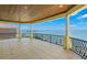 Covered balcony with tile flooring and wrought iron railing overlooks a waterfront view at 611 1St S Ave, Tierra Verde, FL 33715