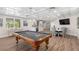 Finished basement featuring a billiards area with modern flooring and kitchenette at 611 1St S Ave, Tierra Verde, FL 33715
