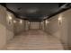 Finished basement space with a star-patterned ceiling, luxury vinyl plank floors, and sconce lighting at 611 1St S Ave, Tierra Verde, FL 33715