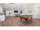Finished basement featuring a billiards area with modern flooring and kitchenette at 611 1St S Ave, Tierra Verde, FL 33715