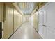 Long unfinished basement hallway with a painted ceiling, concrete floors, and white doors at 611 1St S Ave, Tierra Verde, FL 33715