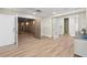 Finished basement area featuring wood-look floors, a decorative ceiling, and multiple doors at 611 1St S Ave, Tierra Verde, FL 33715