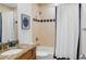 Cozy bathroom with a shower and tub combination featuring diamond-patterned tiles and a granite countertop sink at 611 1St S Ave, Tierra Verde, FL 33715