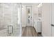 Bathroom with a glass shower, white vanity, and a view through a doorway to the outside at 611 1St S Ave, Tierra Verde, FL 33715