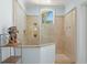 Walk-in shower with tiled walls and glass doors, perfect for a relaxing experience at 611 1St S Ave, Tierra Verde, FL 33715