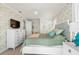 Cozy bedroom with a decorative wallpaper, fan, dresser, and ample natural light at 611 1St S Ave, Tierra Verde, FL 33715