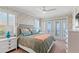 Inviting bedroom with decorative wallpaper, French doors to a balcony, and plush furnishings at 611 1St S Ave, Tierra Verde, FL 33715
