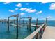 Beautiful boat dock features a boat lift and wood planking out to deep, navigable water at 611 1St S Ave, Tierra Verde, FL 33715