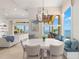 Bright dining area with banquette seating, chandelier, and stunning water views at 611 1St S Ave, Tierra Verde, FL 33715