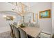 Formal dining room with grand chandelier, columned archways, and seating for ten at 611 1St S Ave, Tierra Verde, FL 33715