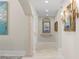 Hallway with decorative columns and art niche that is bathed in light at 611 1St S Ave, Tierra Verde, FL 33715