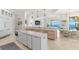 Open kitchen with ocean views, double islands, custom cabinetry, and stainless steel appliances at 611 1St S Ave, Tierra Verde, FL 33715