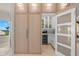 Convenient butler's pantry with wine fridge, beverage center, and custom storage at 611 1St S Ave, Tierra Verde, FL 33715