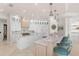 Bright kitchen boasts marble countertops, pendant lighting, breakfast bar, and modern appliances at 611 1St S Ave, Tierra Verde, FL 33715