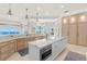 Gourmet kitchen featuring marble countertops, custom cabinetry, and panoramic water views at 611 1St S Ave, Tierra Verde, FL 33715