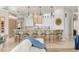 Open concept kitchen with barstool seating, modern lighting, and built-in cabinets at 611 1St S Ave, Tierra Verde, FL 33715