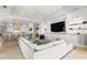 Open-concept living area with built-ins, adjacent to kitchen with breakfast bar seating at 611 1St S Ave, Tierra Verde, FL 33715