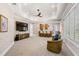 Spacious living room featuring a ceiling fan, a wet bar, and ample seating at 611 1St S Ave, Tierra Verde, FL 33715
