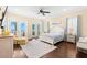 Bright main bedroom featuring French doors to a balcony, a ceiling fan, and wood flooring at 611 1St S Ave, Tierra Verde, FL 33715