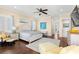 Open main bedroom with wood floors, soft natural light, and comfortable furnishings at 611 1St S Ave, Tierra Verde, FL 33715
