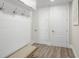 Mudroom with shiplap wall, coat hooks, bench seating, and wood-look floors at 611 1St S Ave, Tierra Verde, FL 33715