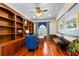 Well-appointed office with custom bookshelves, hardwood floors, and natural light at 611 1St S Ave, Tierra Verde, FL 33715