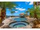 Beautiful backyard pool with a spa, tiki bar, and lush landscaping at 611 1St S Ave, Tierra Verde, FL 33715