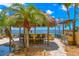 Outdoor tiki bar featuring bar seating and a built-in grill by the pool at 611 1St S Ave, Tierra Verde, FL 33715