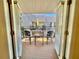 Balcony with chairs and a table overlooking landscaping and other buildings at 702 Lyndhurst St # 822, Dunedin, FL 34698