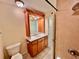 Bathroom vanity with wood cabinets and decorative mirror, adding charm at 702 Lyndhurst St # 822, Dunedin, FL 34698