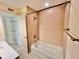 Bathroom with a tub and shower combo, tiled walls, and functional fixtures at 702 Lyndhurst St # 822, Dunedin, FL 34698