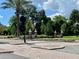 Inviting Dunedin community entrance with brick signage, lush landscaping, and mature palm trees under a partly cloudy sky at 702 Lyndhurst St # 822, Dunedin, FL 34698