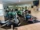 Bright fitness center featuring mirrored walls, exercise equipment, and tiled floors at 702 Lyndhurst St # 822, Dunedin, FL 34698