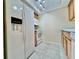 Bright kitchen with stainless steel appliances, tile floor, and wood cabinets at 702 Lyndhurst St # 822, Dunedin, FL 34698