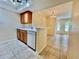 Kitchen features wood cabinets, and a tile floor, creating an open flow into the living space at 702 Lyndhurst St # 822, Dunedin, FL 34698