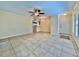 Open-concept living room featuring neutral tile floors and seamless flow to the kitchen and dining areas at 702 Lyndhurst St # 822, Dunedin, FL 34698