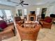 Cozy living room with tile floors, rattan furniture, decorative art and a ceiling fan at 702 Lyndhurst St # 822, Dunedin, FL 34698