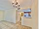 Living room showcasing tile flooring and view to the kitchen at 702 Lyndhurst St # 822, Dunedin, FL 34698