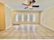 Spacious living room with neutral tile floors, modern ceiling fan and plenty of natural light at 702 Lyndhurst St # 822, Dunedin, FL 34698