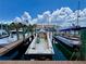 Exterior view of boat slip in a marina with luxury boats and sailboats docked on a sunny day at 702 Lyndhurst St # 822, Dunedin, FL 34698