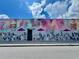 Exterior mural of Welcome Home The Living Room with images of many dogs at 702 Lyndhurst St # 822, Dunedin, FL 34698