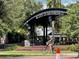 Park entrance with City of Dunedin sign and a cyclist passing by the lush green space at 702 Lyndhurst St # 822, Dunedin, FL 34698
