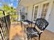 Relaxing balcony features beautiful black wrought iron furniture and a serene outdoor view at 702 Lyndhurst St # 822, Dunedin, FL 34698